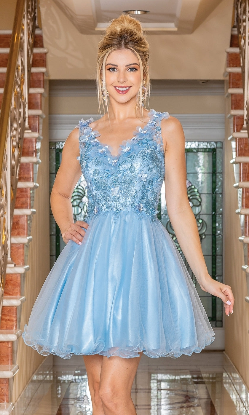 A woman stands indoors between two staircases wearing the Flower-Bodice Sleeveless Short Hoco Dress 3297, a light blue floral appliqué party dress under $100 that's perfect for homecoming.